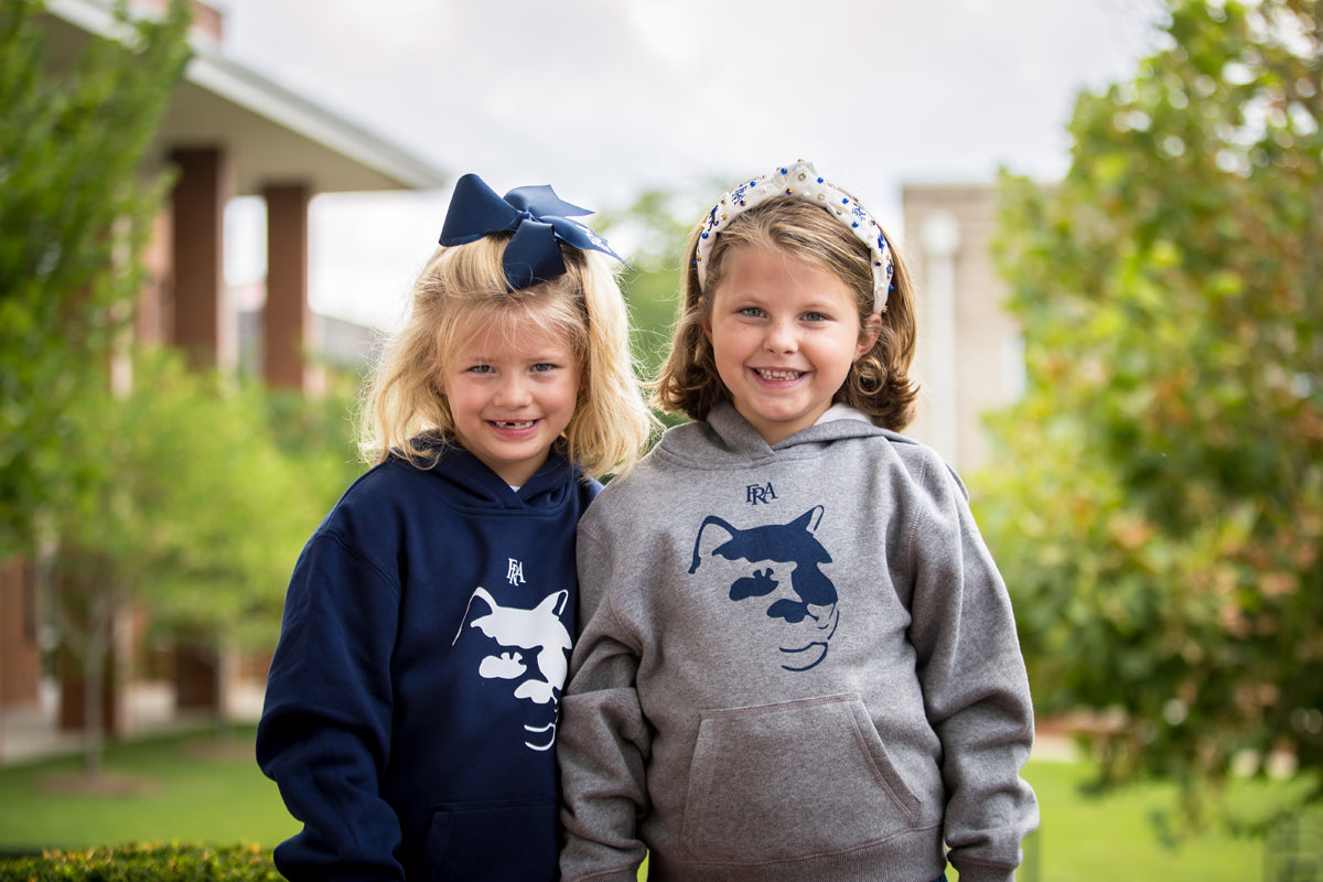 Young girls wearing FRA Spirit Store apparel.