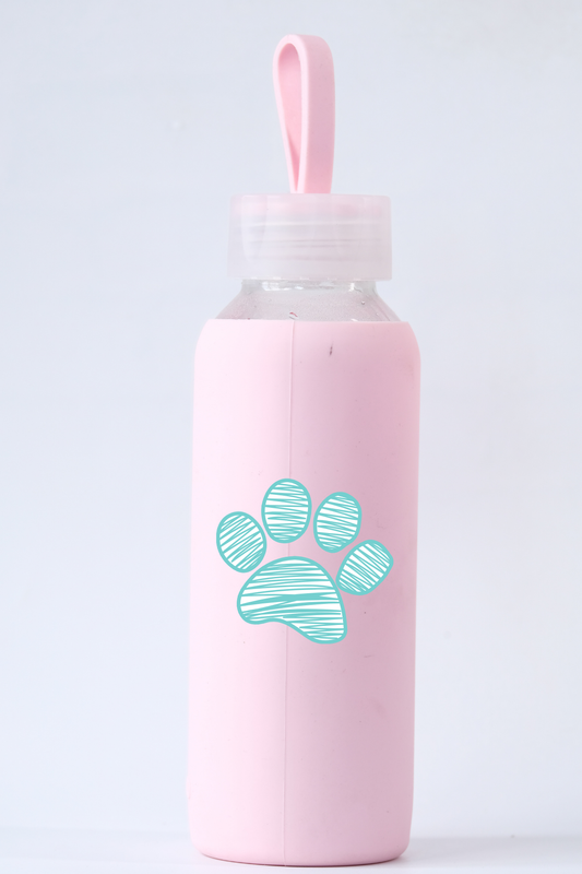 Pink water bottle with a paw print design on a light gray background